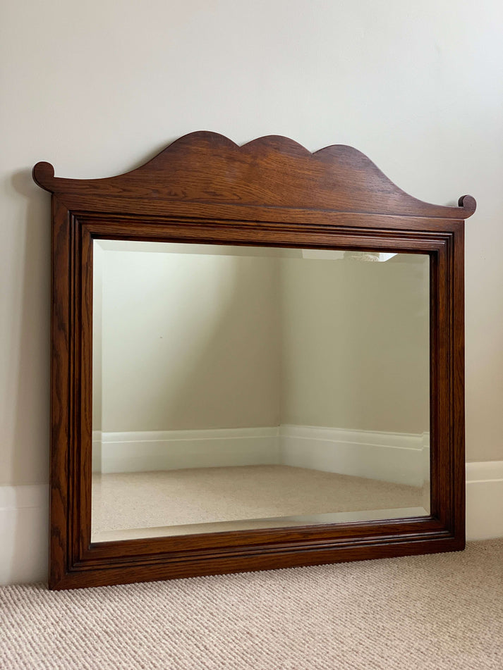 Antique oak-framed bevelled mirror
