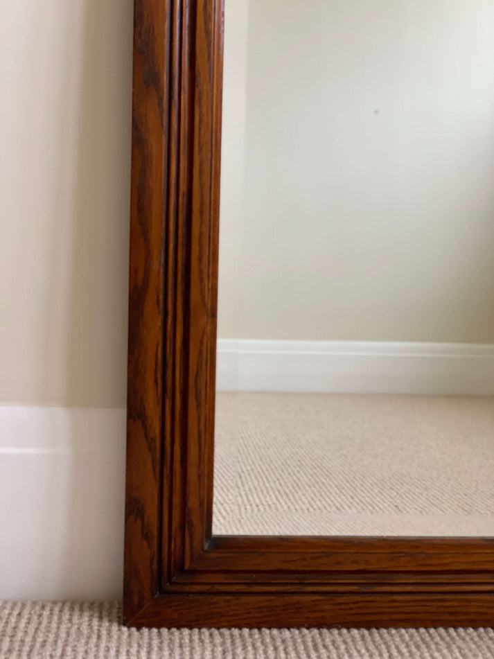 Antique oak-framed bevelled mirror