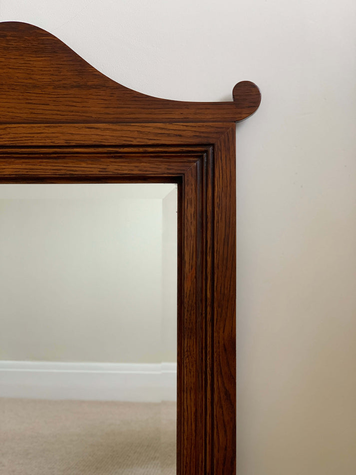 Antique oak-framed bevelled mirror
