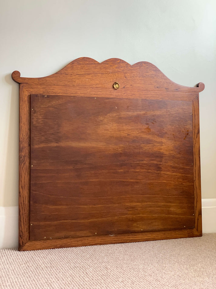 Antique oak-framed bevelled mirror