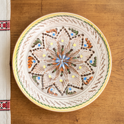 Cara serving plate in a Romanian-inspired rustic table setting