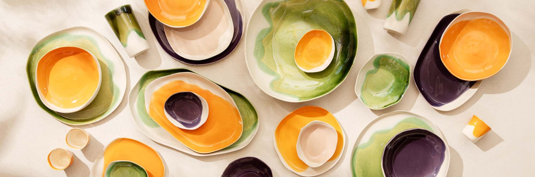 Colorful ceramic dishes arranged on a light background