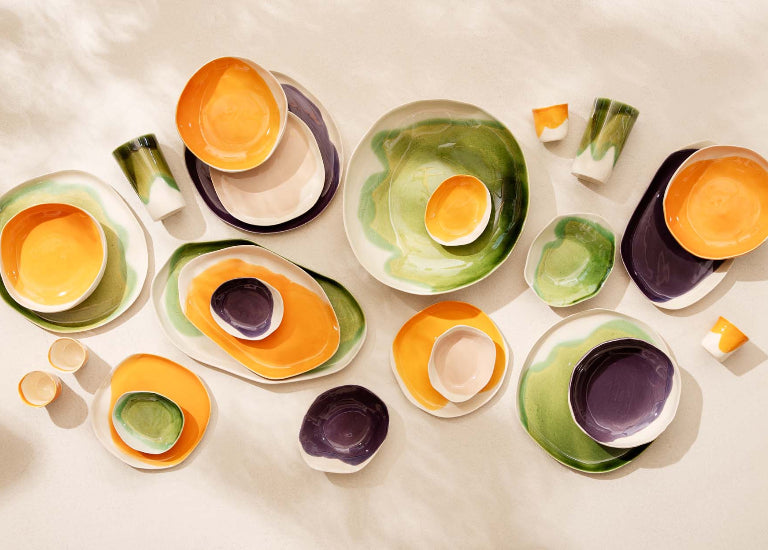 Colorful ceramic dishes arranged on a light background