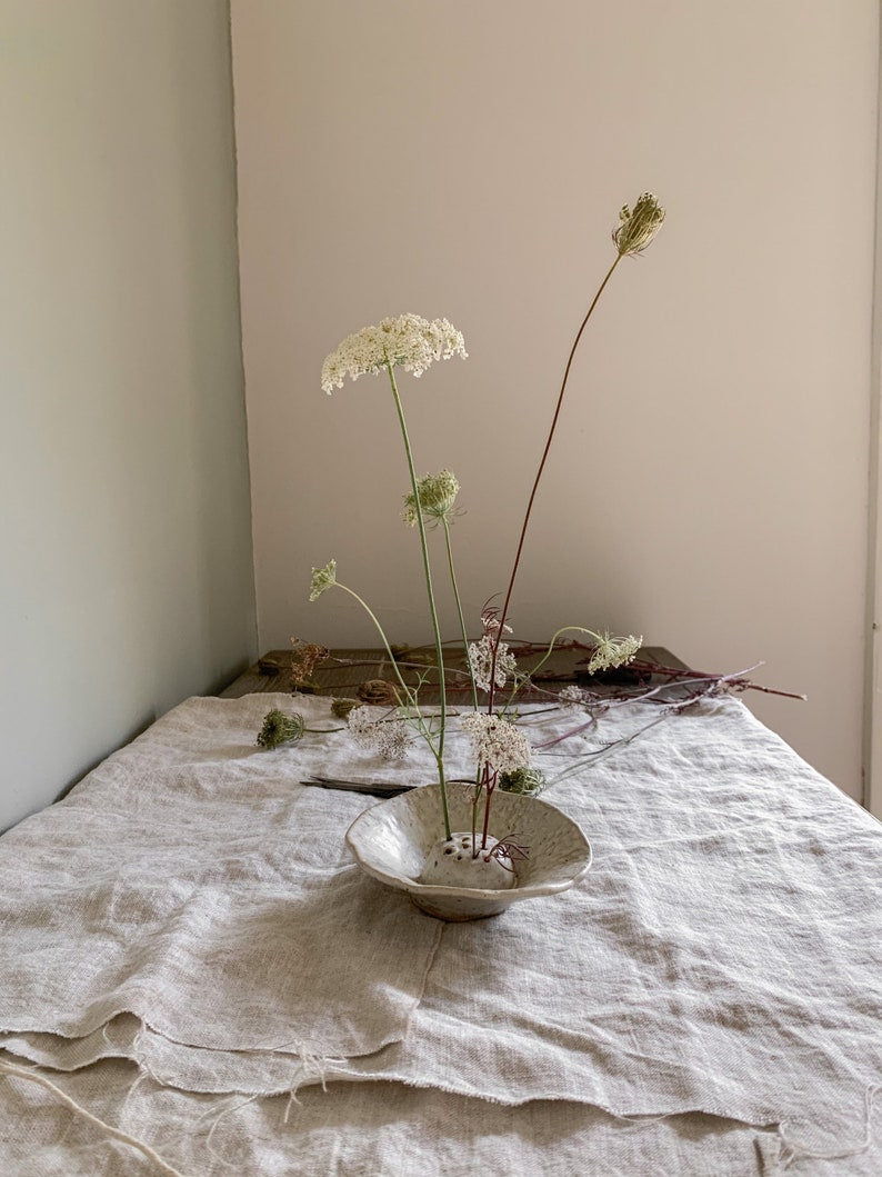 Japanese flower arranging Ikebana in cream off white Glaze