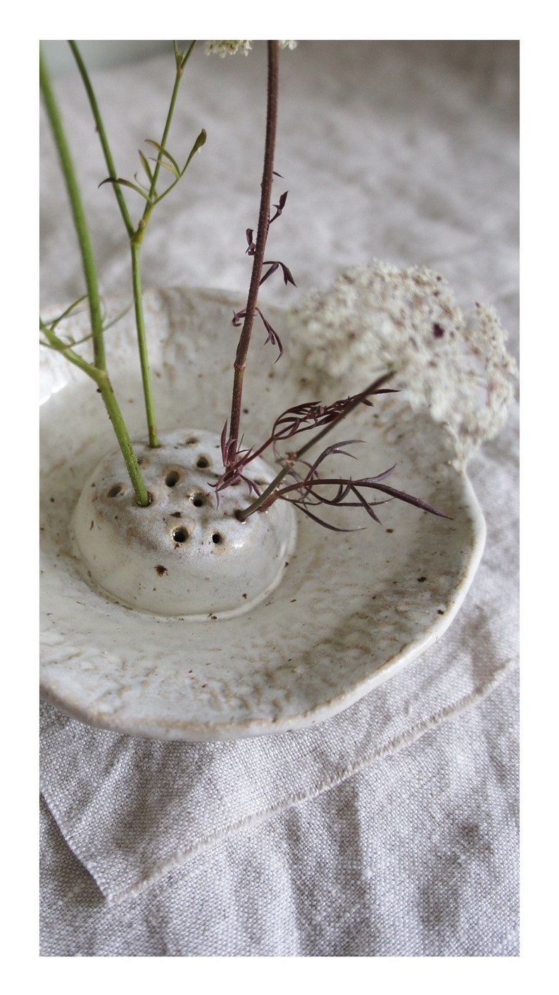 Japanese flower arranging Ikebana in cream off white Glaze