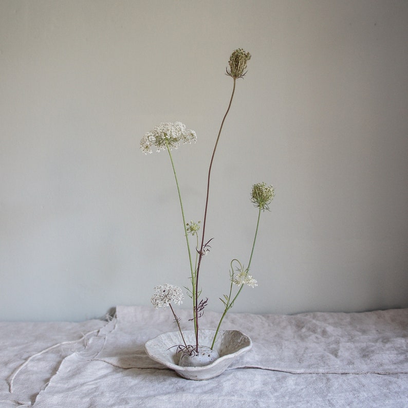 Japanese flower arranging Ikebana in cream off white Glaze