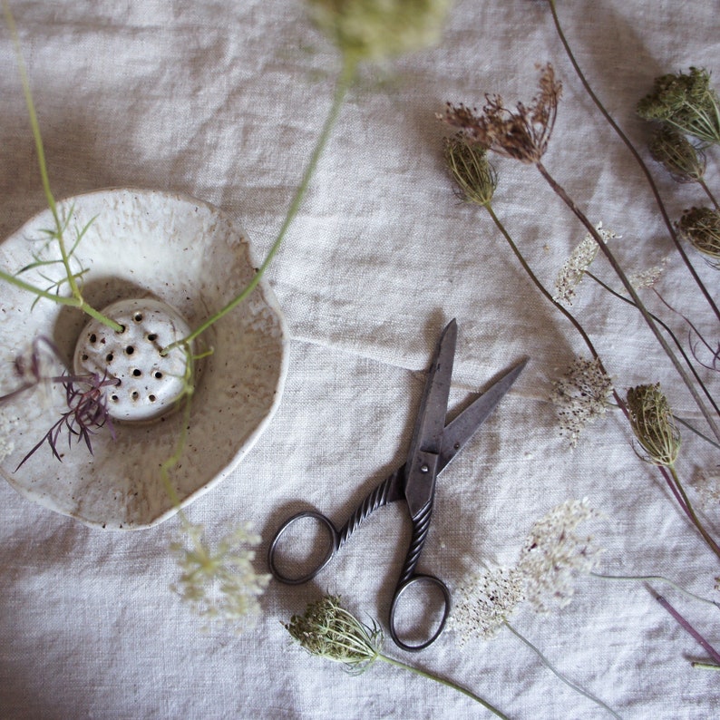 Japanese flower arranging Ikebana in cream off white Glaze