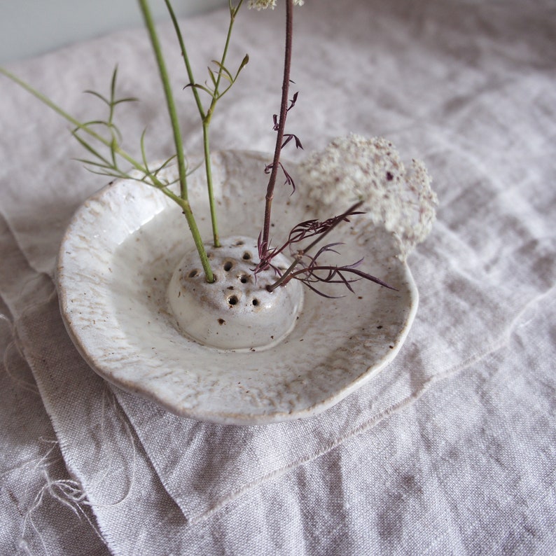 Japanese flower arranging Ikebana in cream off white Glaze