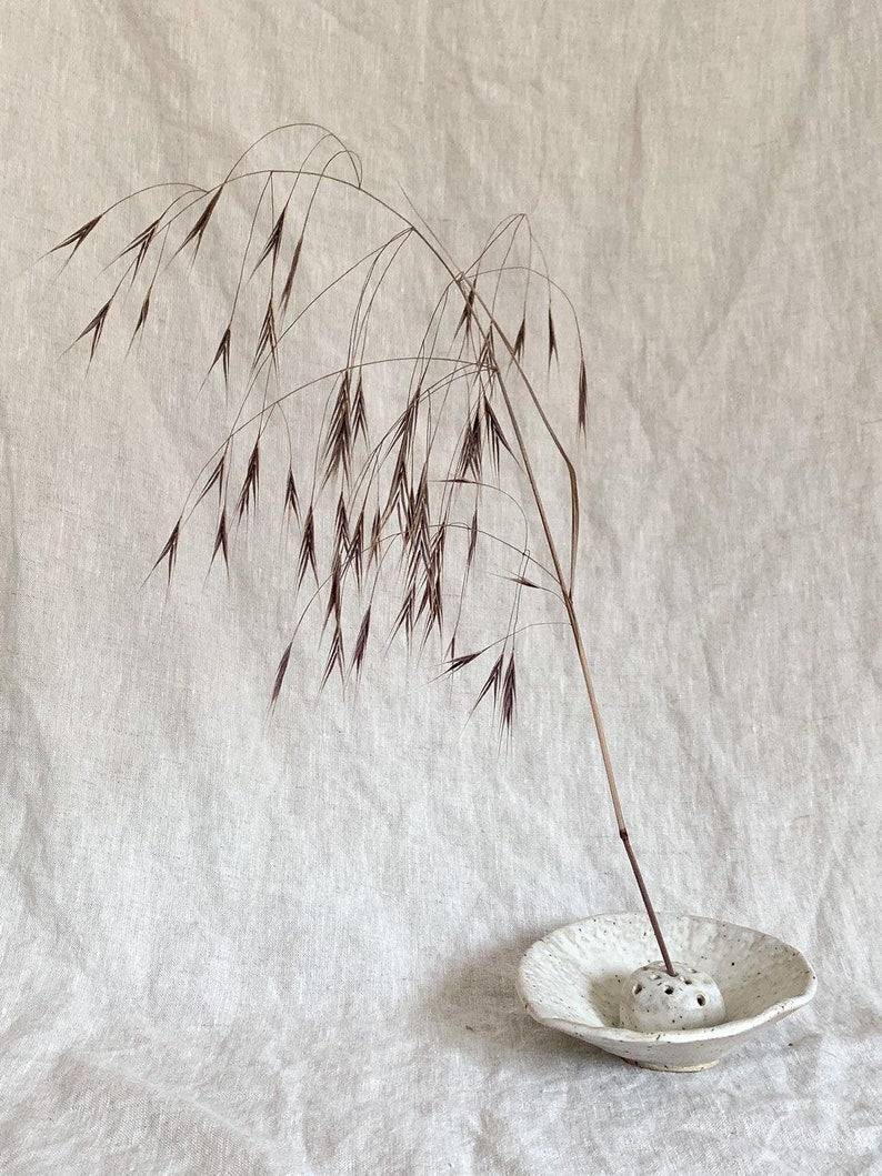 Japanese flower arranging Ikebana in cream off white Glaze