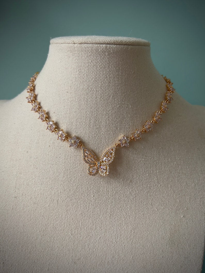 Sparkly gold butterfly white flower choker necklace