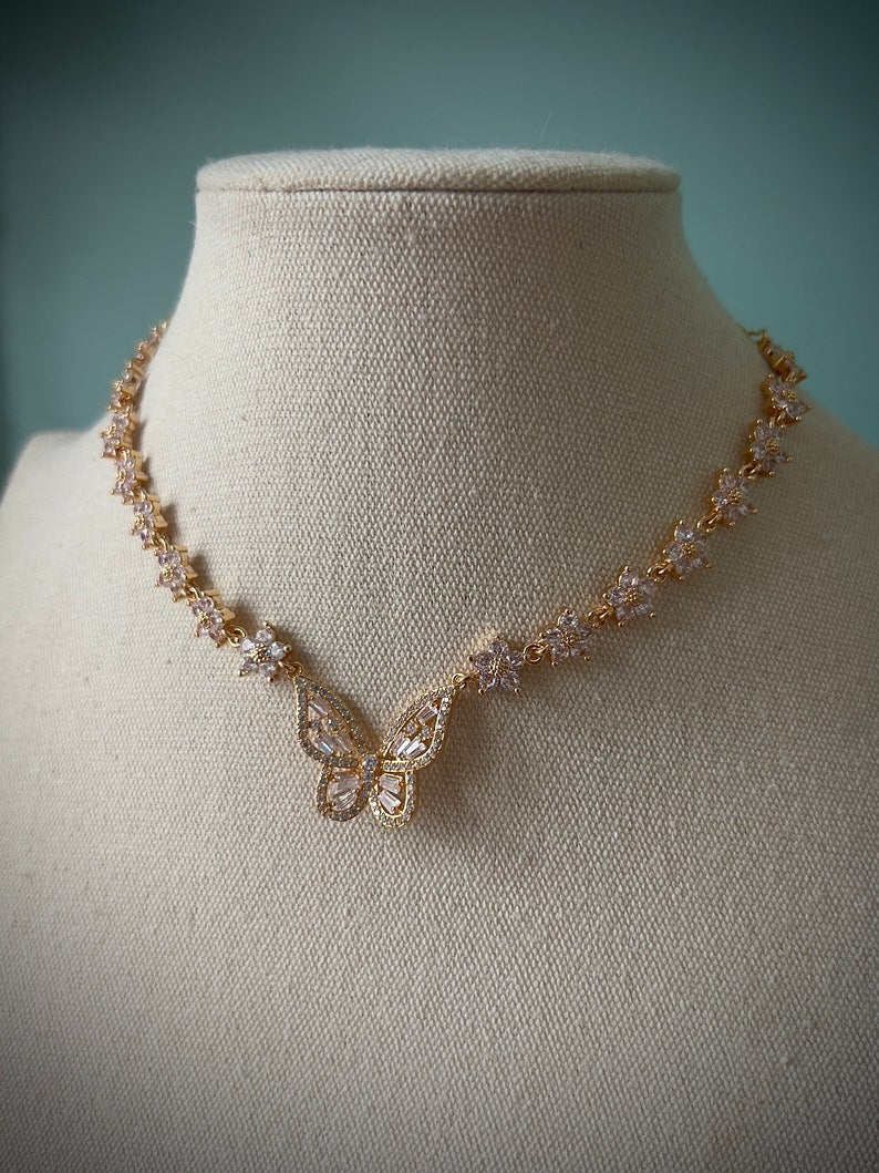 Sparkly gold butterfly white flower choker necklace