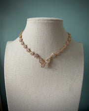 Sparkly gold butterfly white flower choker necklace
