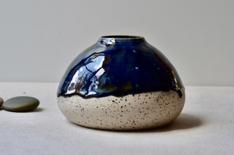 Handmade speckled clay vase with blue glaze