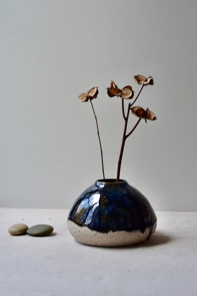 Handmade speckled clay vase with blue glaze
