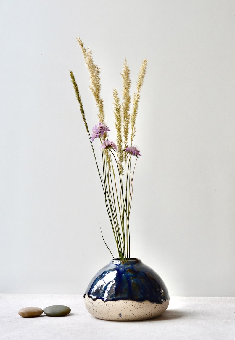 Handmade speckled clay vase with blue glaze
