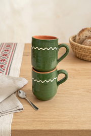 Moss green cylinder mugs in a Romanian-inspired breakfast setting