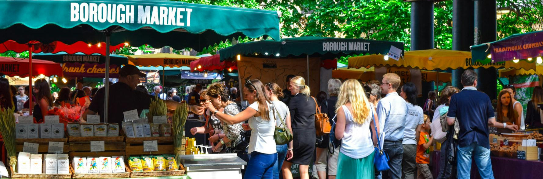 Borough Market with people shopping under green canopies